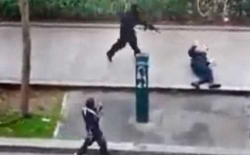 In this photo, captured from a video, gunmen are seen pointing their guns at a police officer outside the Charlie Hebdo office in Paris. He was later shot in the head.