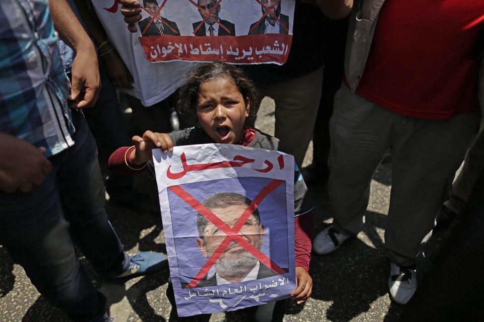 Egyptian men, women and children rioting against Morsi and his Muslim Brotherhood, chanting 